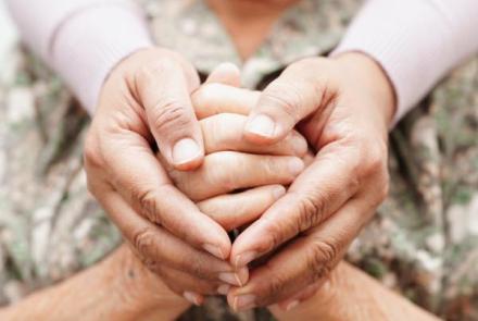 Person holding another person's hands