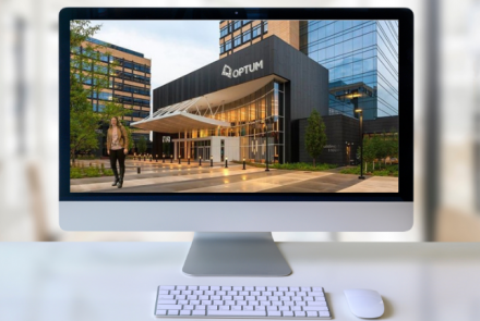 Computer monitor displaying a photoshopped image of Katelyn Balchin in front of her internship placement location, Optum Healthcare.